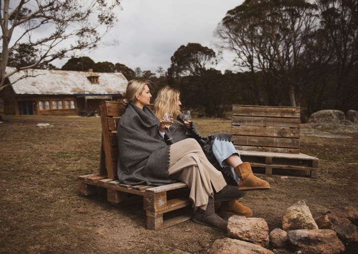 Having drinks and relax in the front of bonfire in Cooma, Snowy Mountains